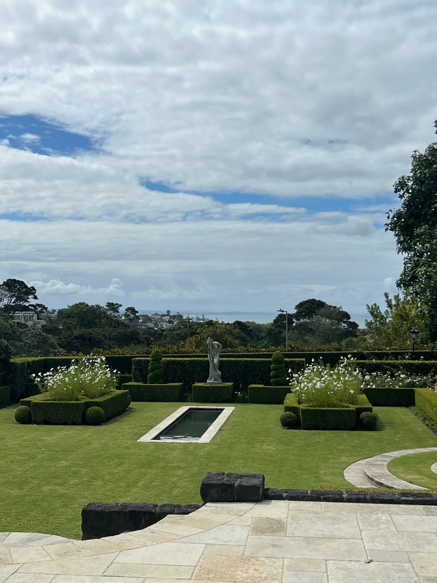 Formal lawn and garden area with clipped hedges